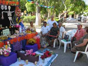 The whole family sitting around the alter they made. 